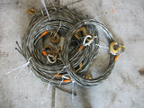 Coiled steel winch cable with hooks.